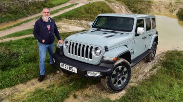 Auto Express senior test editor Dean Gibson standing next to a Jeep Wrangler